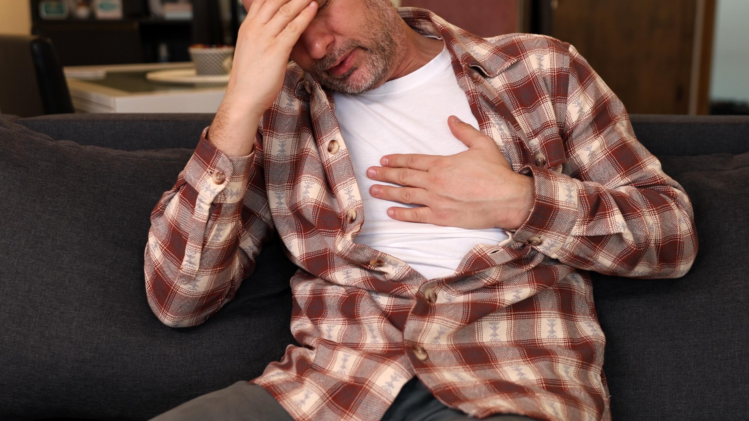 Woman experiencing sudden heart racing while resting at home